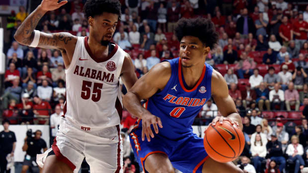 Feb 21, 2024; Tuscaloosa, Alabama, USA; Florida Gators guard Zyon Pullin (0) dribbles around Alabama Crimson Tide guard Aaron Estrada (55) during the second half at Coleman Coliseum. Mandatory Credit: Butch Dill-USA TODAY Sports  